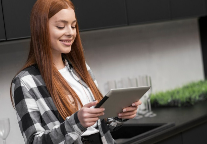 Happy woman holding ipad
