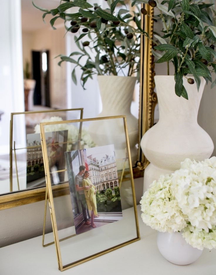 home interior decoration - personal memorabilia - picture frames - plant - mirror