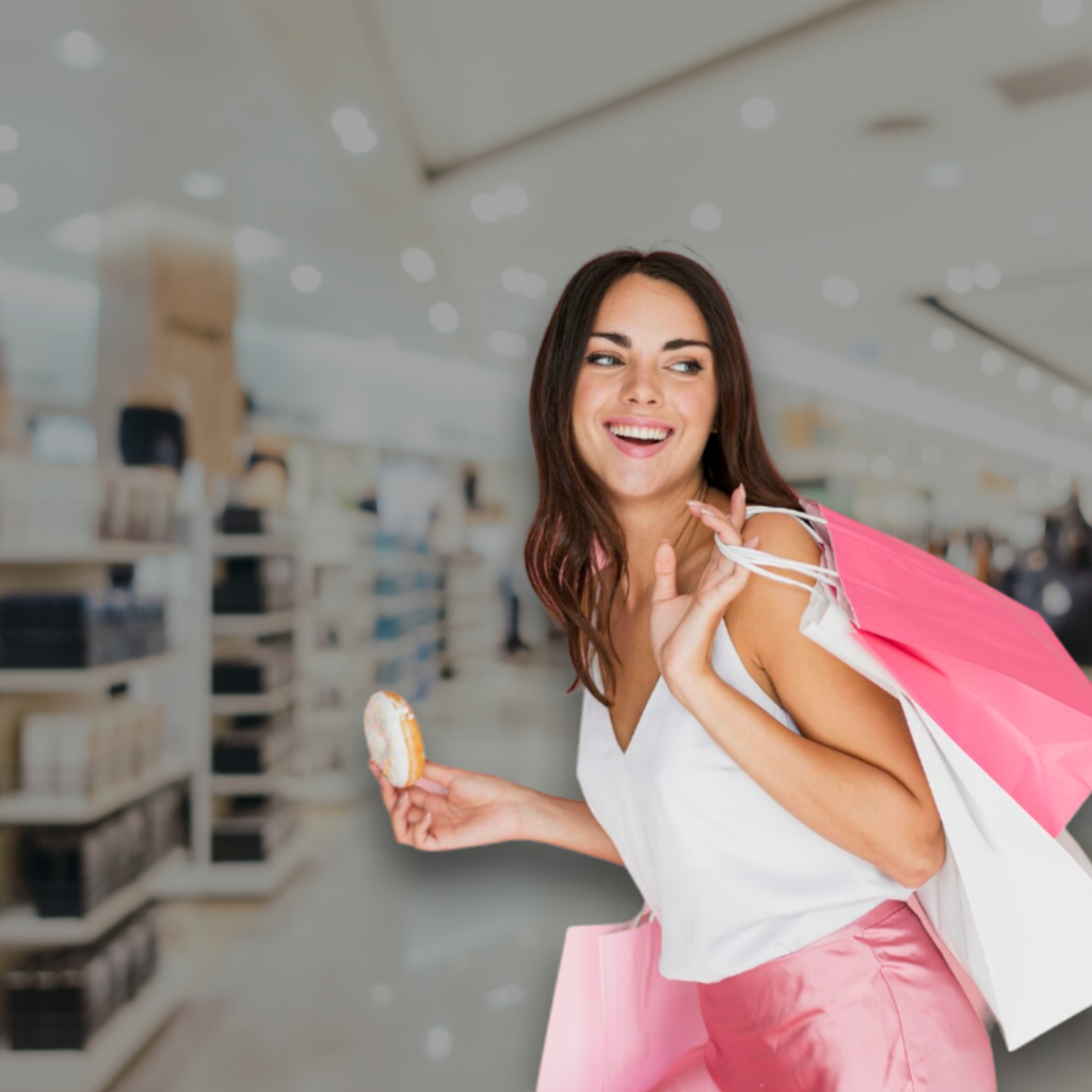 shopping woman holding a donut in her hand - store bags - clothing store in the background - cyber monday - offers